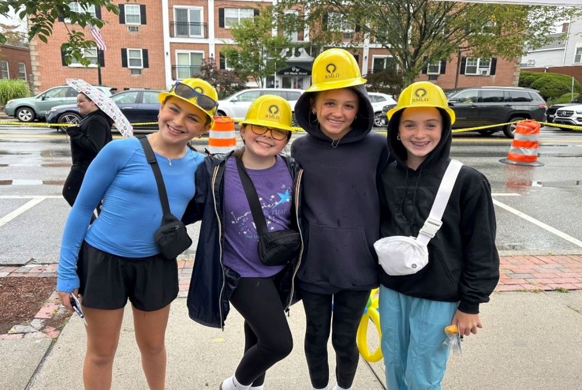 Young resident pose for a photo in their RMLD yellow hats.